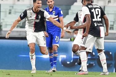 epa08567895 Juventusâ€™ Cristiano Ronaldo (L) celebrates after scoring the 1-0 goal during the Italian Serie A soccer match Juventus FC vs UC Sampdoria at the Allianz stadium in Turin, Italy, 26 July 2020. EPA/ALESSANDRO DI MARCO