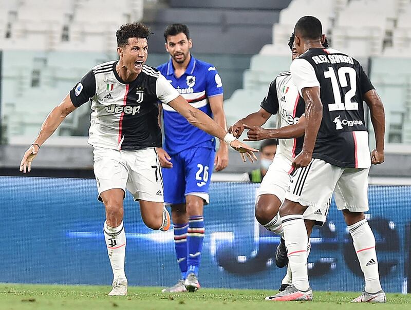 epa08567895 Juventusâ€™ Cristiano Ronaldo (L) celebrates after scoring the 1-0 goal during the Italian Serie A soccer match Juventus FC vs UC Sampdoria at the Allianz stadium in Turin, Italy, 26 July 2020.  EPA/ALESSANDRO DI MARCO