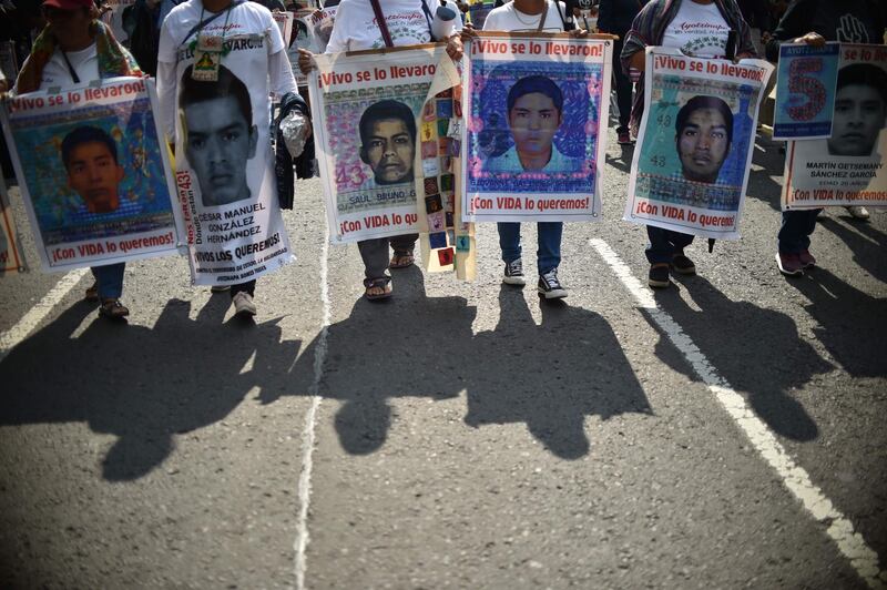 People protest in Mexico City, to mark five years of the disappearance of the 43 students of the teaching training school in Ayotzinapa who went missing on September 26, 2014. AFP