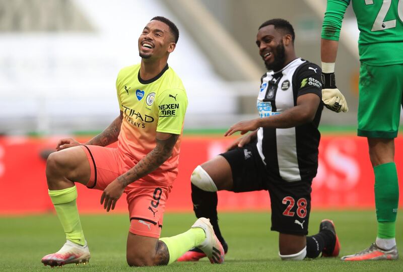 Newcastle's Danny Rose and Gabriel Jesus of Manchester City take a knee. EPA