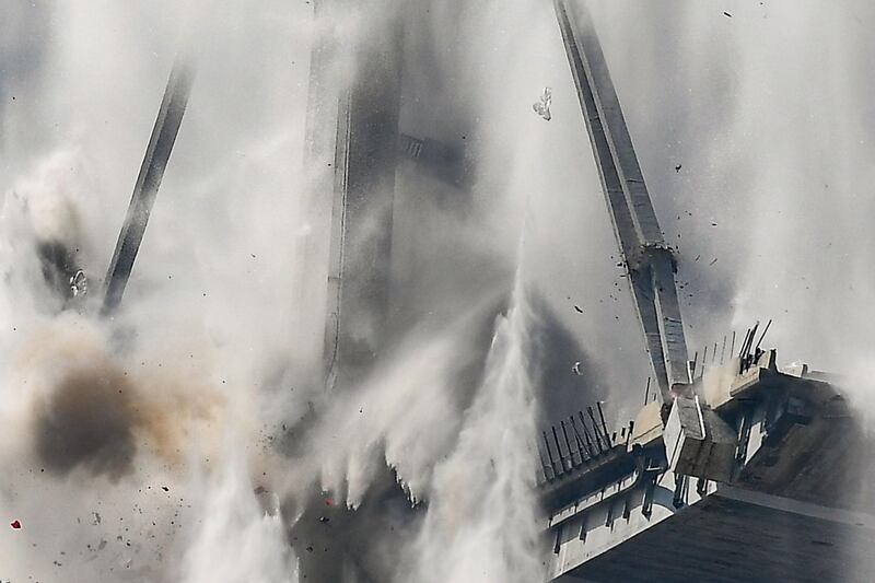 Explosive charges blow up the eastern pylons of Genoa's Morandi motorway bridge in Genoa, Italy. AFP