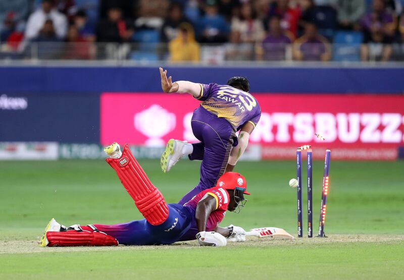 Abu Dhabi Knight Riders' Zawar Farid almost runs out Dubai Capitals' Rovman Powell.