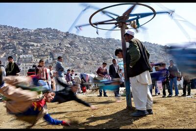 Afghan boys play near the Sakhi shrine in Kabul, the centre of the Afghan new year celebrations, during Nowruz festivities. Massoud Hossaini / AFP