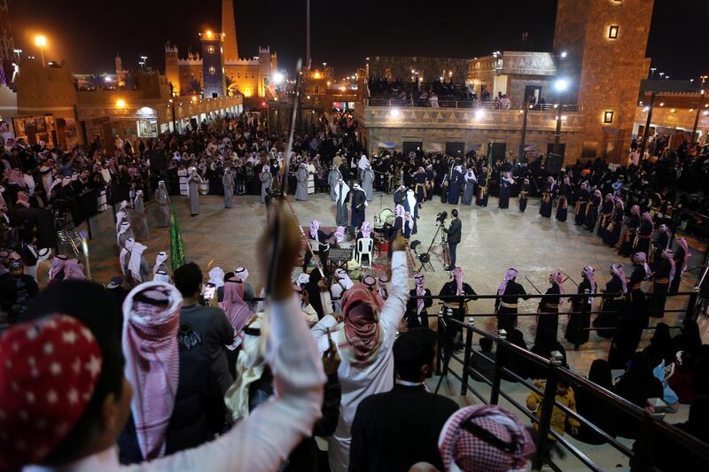 Saudi men perform a traditional dance during Janadriyah Cultural Festival. REUTERS