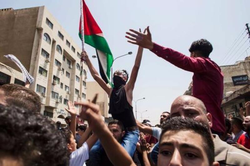 Mourners waving the Palestinian flag march at the funeral of Mohammed Al Jawawdeh, who was killed by an Israeli security guard, in Amman on July 25, 2017. Lindsey Leger / AP