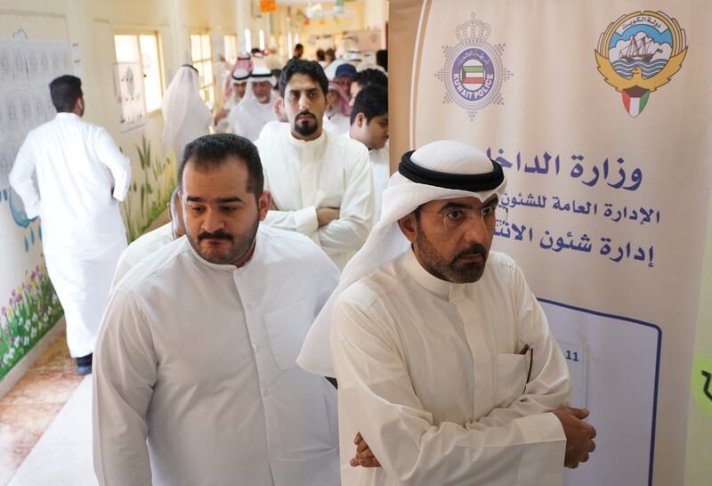 People wait in line to vote during parliamentary elections at a polling station in Kuwait City. Reuters