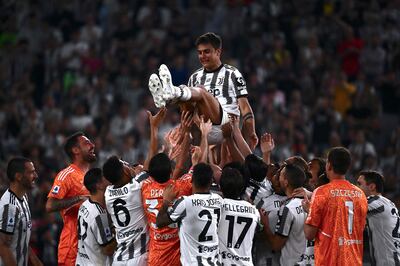 Paulo Dybala is thrown in the air by Juventus teammates at the end of his final match for the club against Lazio at the Allianz Stadium on May 16, 2022. AFP
