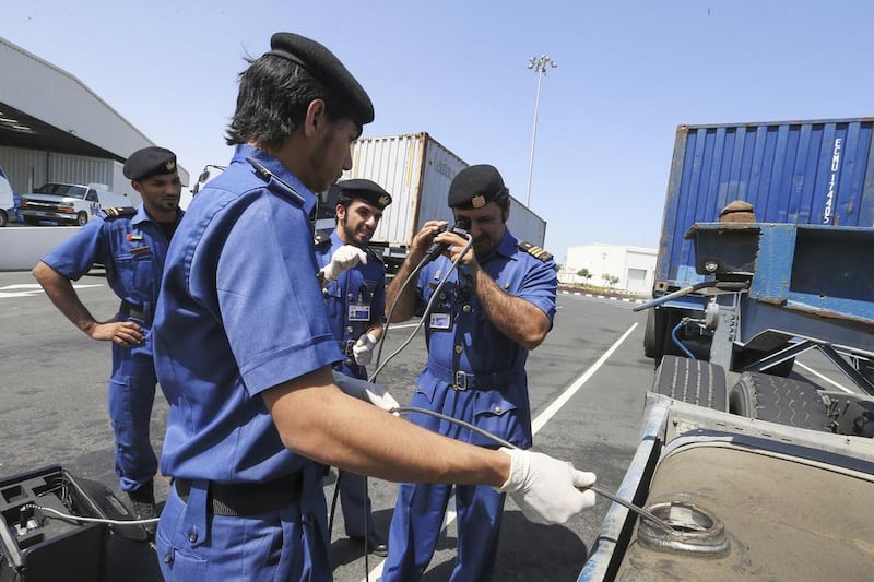 Dubai Customs inspectors use a scope camera to check the fuel tank of a lorry for any suspicious materials in Jebel Ali Port. Sarah Dea / The National