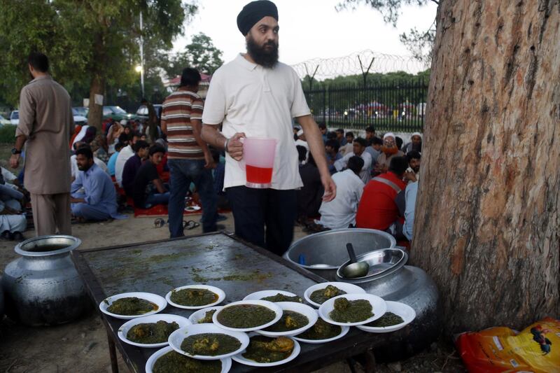 Sikhs distribute free meals for Muslims to break the fast in Islamabad, Pakistan.  EPA