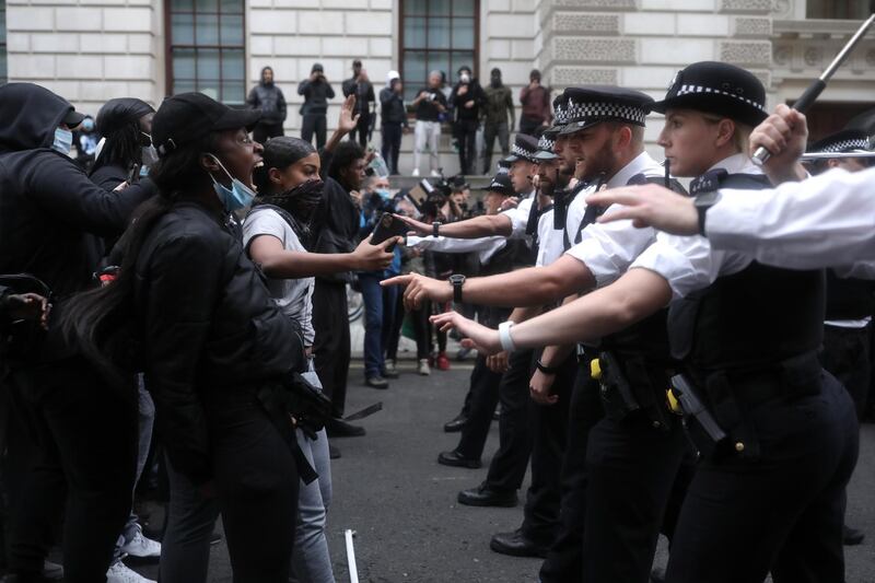 LONDON, ENGLAND - JUNE 03: Police officers gesture to demonstrators during a Black Lives Matter protest on June 3, 2020 in London, United Kingdom. The death of an African-American man, George Floyd, while in the custody of Minneapolis police has sparked protests across the United States, as well as demonstrations of solidarity in many countries around the world. (Photo by Dan Kitwood/Getty Images)