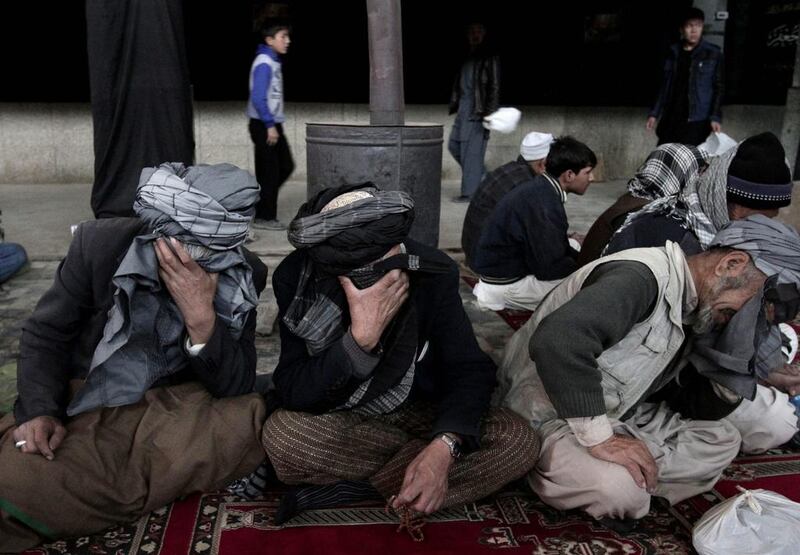 Afghan Shiites mourn a day ahead of Ashura at a mosque in Kabul, Afghanistan. Ashura marks the Shiite Muslims commemoration of the 7th century killing of their most revered Saint Imam Hussein, the grandson of Prophet Mohammad, a symbol of martyrdom for Shiites. Rahmat Gul / AP Photo