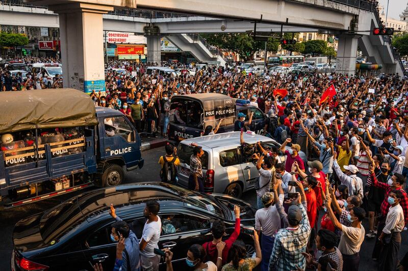 Protesters attempt to block riot police arriving to form a barricade outside Yangon City Hall in Yangon, Myanmar. Getty Images