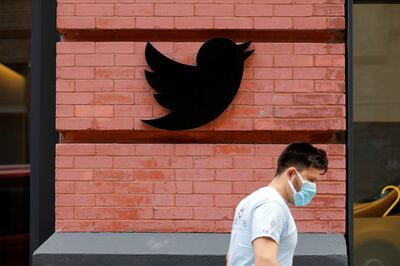 A person in a mask walks by the New York Twitter offices. Reuters