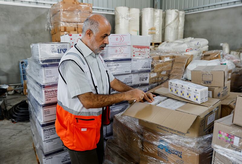A Red Crescent worker sorts aid for Palestinians in Khan Younis, in the southern part of the blockaded enclave. Reuters