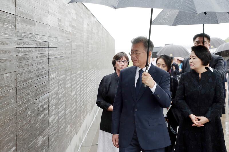 South Korean President Moon Jae-in views a wall inscribed with names of the victims of Argentina's past dictatorship. EPA