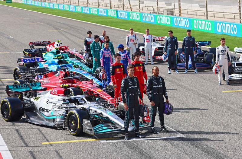 Drivers pose for photos during the first day of F1 pre-season testing at the Bahrain International Circuit. AFP