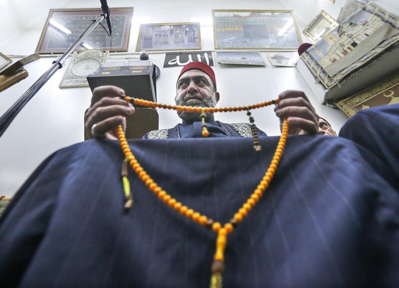 A Muezzin holds a string of prayer beads at the Umayyad Mosque in the ancient quarters of Damascus. AFP
