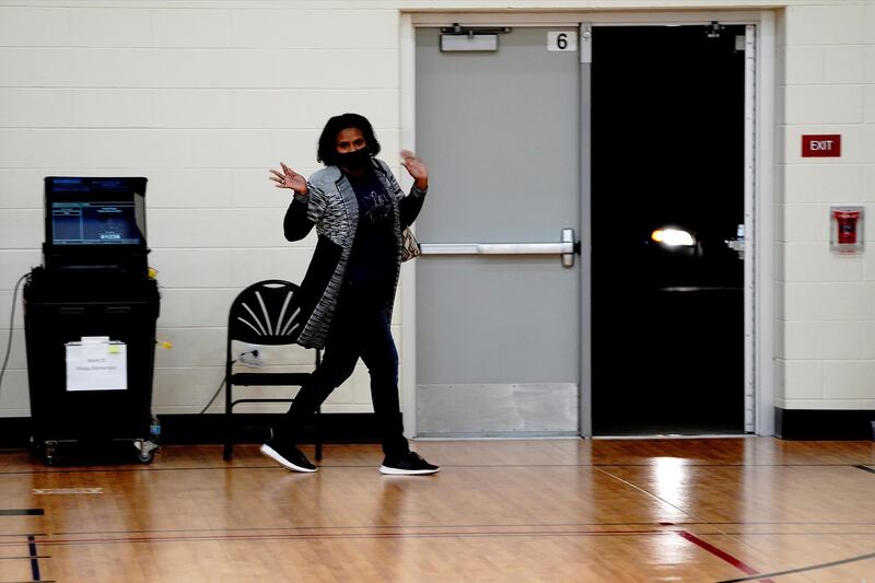 Martina Brown celebrates after being the last voter to cast her ballot at a polling station inside Knapp Elementary School on Election Day in Racine, Racine County, Wisconsin. Reuters