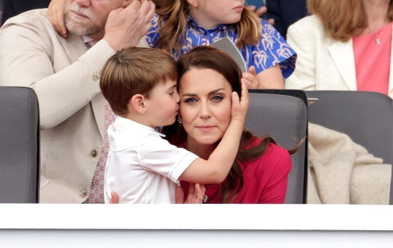 Prince Louis hugs his mother Kate. AP