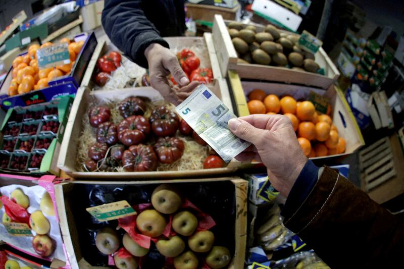 A shopper pays with a euro bank note at a market in France. Food inflation came in above the European Central Bank's target Reuters.