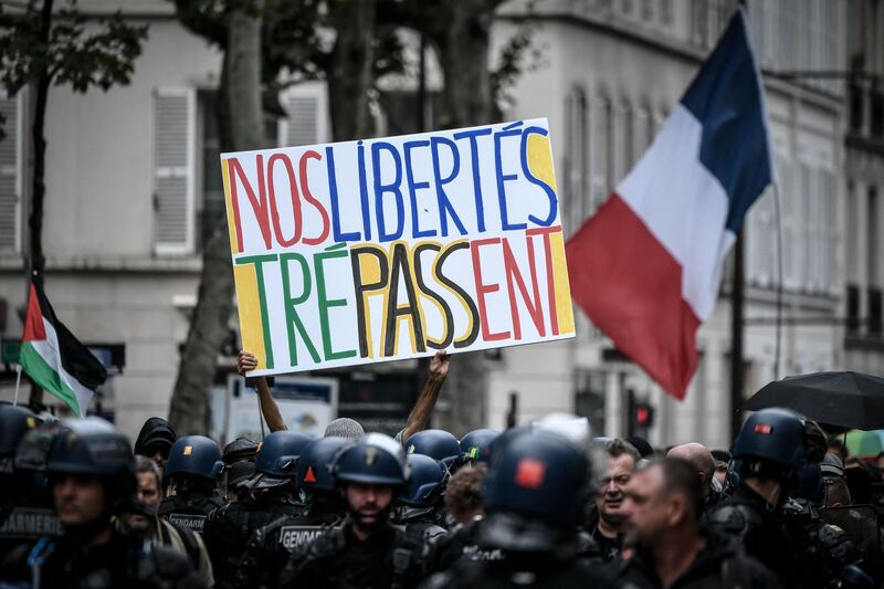 The sign, held by a protester in Paris, reads, 'Our freedom is dying'. AFP