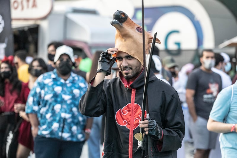 A cosplayer with a horse head mask.