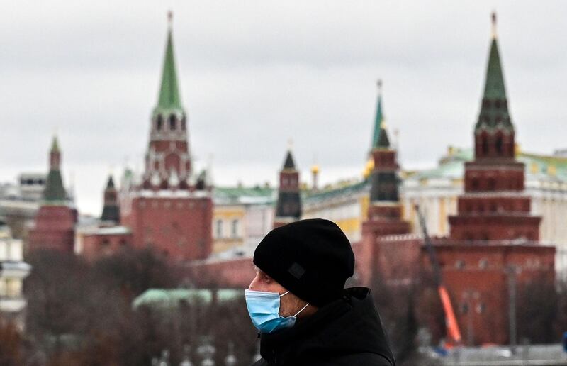 A man wearing a face mask walks on a bridge near the Kremlin in central Moscow. AFP