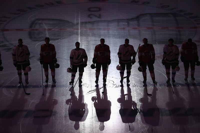 Players stand to attention during the national anthem before the Tampa Bay Lightning against Florida Panthers exhibition game at Scotiabank Arena on Wednesday, July 29. AFP