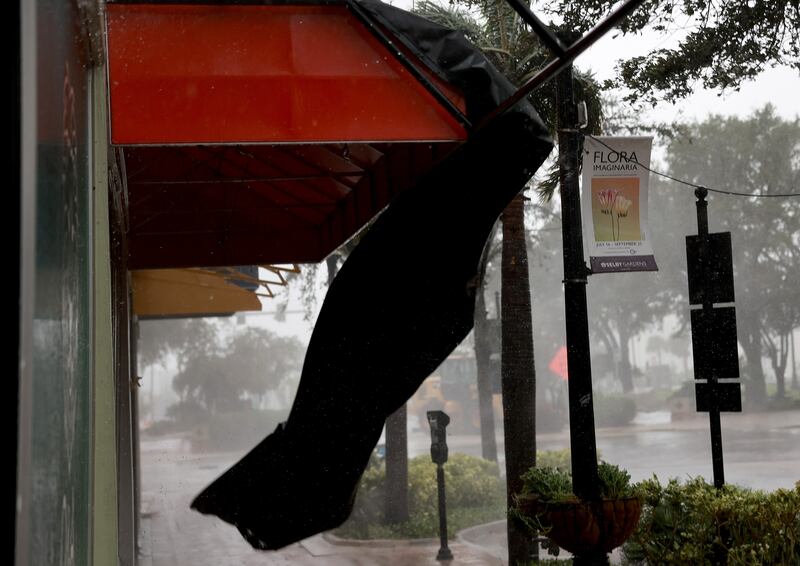 Bunting is torn from an awning in Sarasota. AFP
