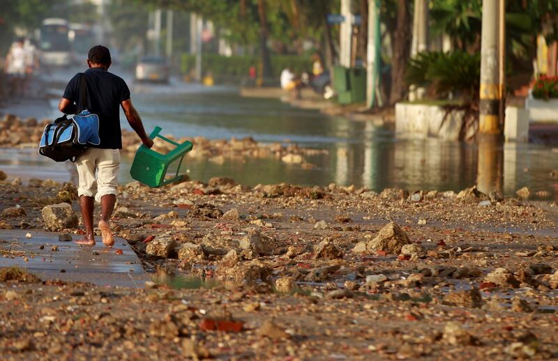 A man walks along an avenue flooded by the passage of hurricane Iota, in Cartagena, Colombia.EPA