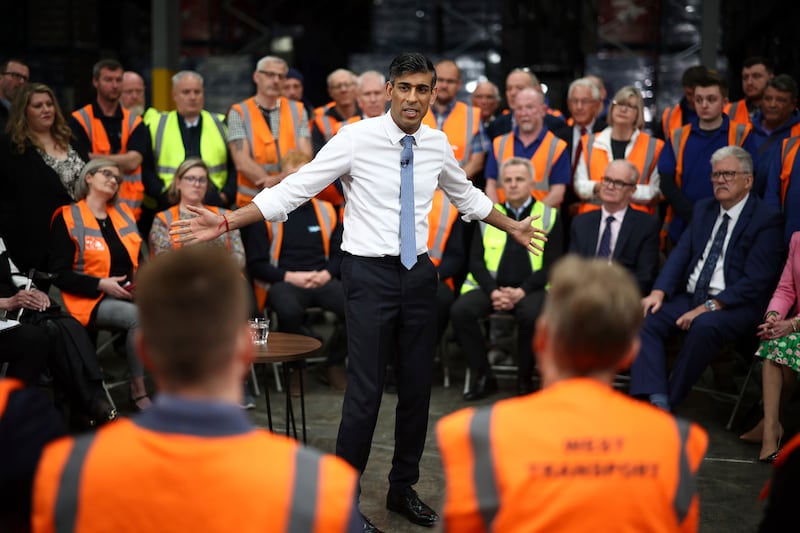 Mr Sunak holds a Q&A with staff of a West Transport distribution centre in Ilkeston in the East Midlands. AP