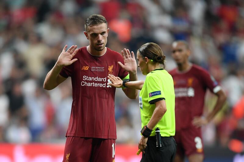 Jordan Henderson of Liverpool argues with referee Stephanie Frappart after a penalty was awarded to Chelsea. Getty Images