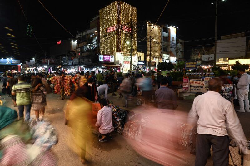 Shoppers at a market ahead of the beginning of Diwali on Tuesday. The global semiconductor shortage has affected manufacturers in India, leading to fewer sales on electronics and cars during the country's festive season. AFP