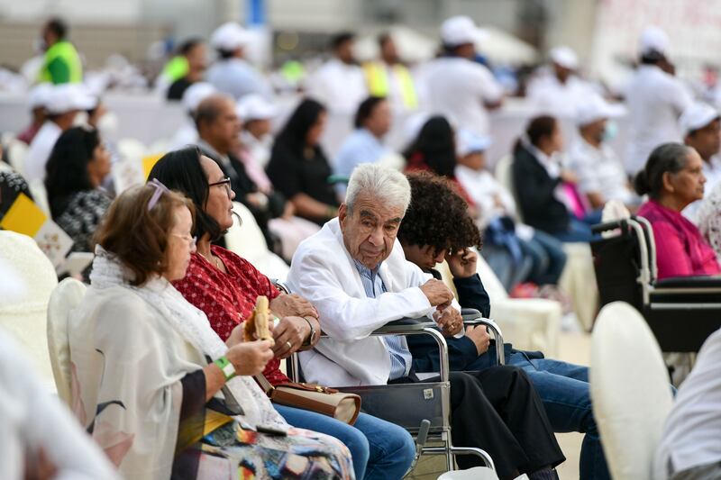 Thousands wait for the mass to begin. Khushnum Bhandari / The National