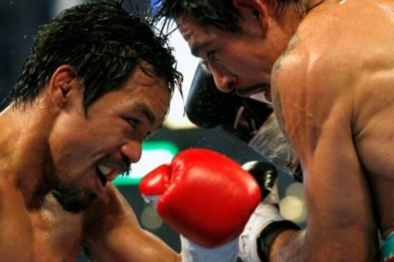Manny Pacquiao of the Philippines (L) fights Antonio Margarito of Mexico during the sixth round of their 12 round WBC World Super Welterweight title boxing fight in Arlington, Texas November 13, 2010. REUTERS/Mike Stone (UNITED STATES - Tags: SPORT BOXING IMAGES OF THE DAY) *** Local Caption ***  DAL08_BOXING-PACQUI_1114_11.JPG
