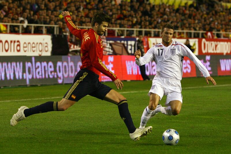 Gerard Pique, left, of Spain clears the ball under pressure from England's David Beckham during his first international match for Spain in a friendly at the Ramon Sanchez Pizjuan Stadium on February 11, 2009 in Seville, Spain. Getty Images
