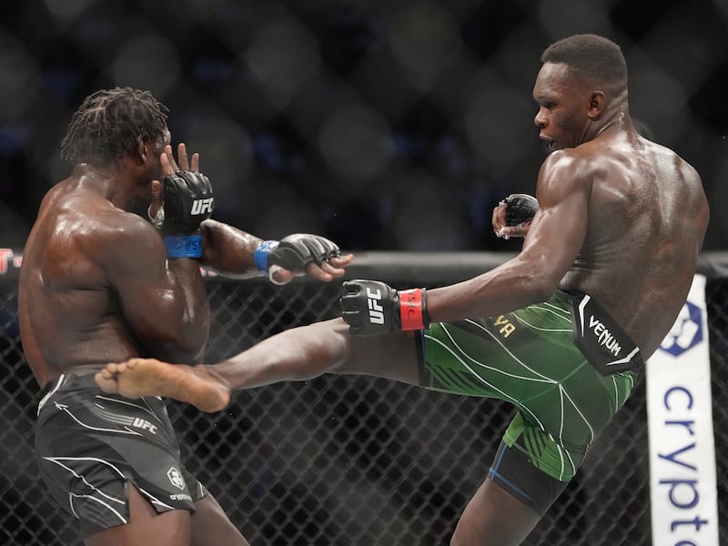 Israel Adesanya lands a kick on Jared Cannonier during their bout at UFC 276. Reuters