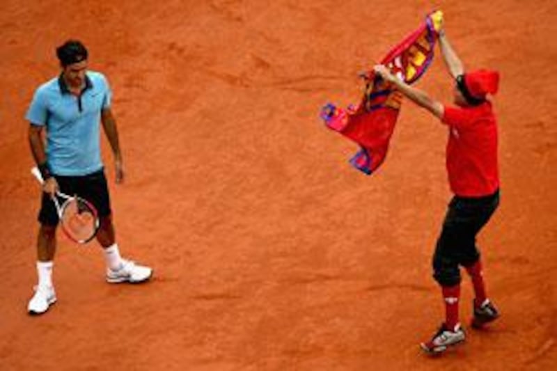 An intruder on the court interferes with Roger Federer during the men's singles final against Robin Soderling of Sweden.