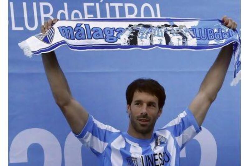 Ruud van Nistelrooy holds a Malaga team scarf.