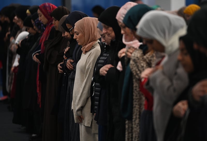 People pray at 22 Bishopsgate in London. EPA