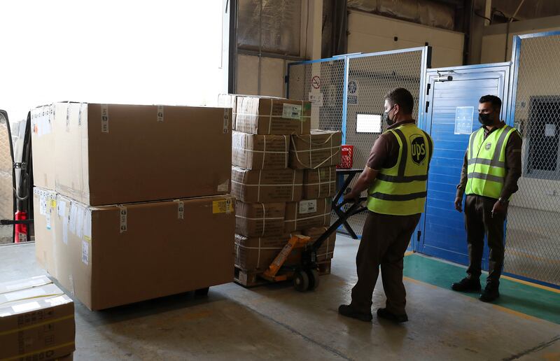 Staff unloading boxes at the UPS warehouse in Jafza in Dubai.