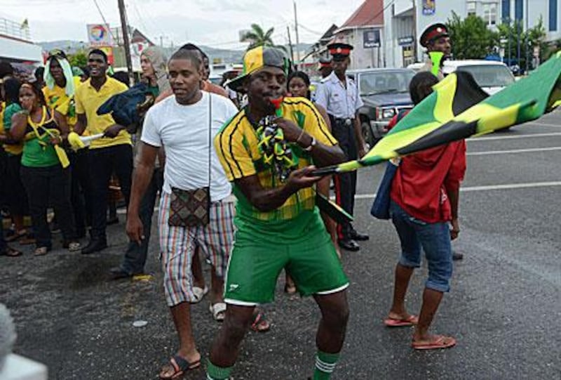 Jamaican fans celebrate Usain Bolt's 100m triumph in Kingston.