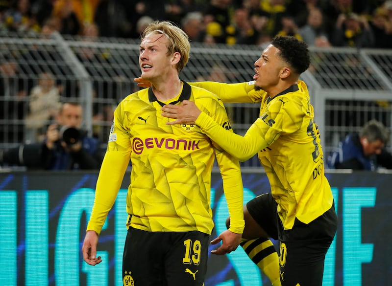 Julian Brandt celebrates with Jadon Sancho after scoring Dortmund's opening goal to level the tie. Reuters