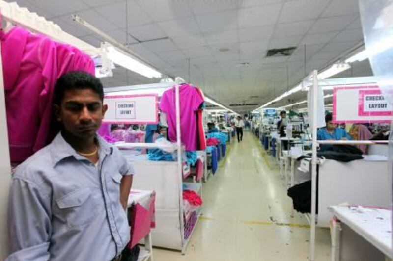 A supervisor stands inside the premises of a Jordan-based garment manufacturer for a top U.S. retailer in Irbid, Jordan, Monday July 12, 2011, where Anil Santha, 46, a Sri Lankan manager, has been accused of rape by a young Bangladeshi worker. A U.S.-based workers' rights group claimed that Santha has been sexually harassing women workers since 2007. Santha, a father of two, faces trial in Jordan for alleged rape - a charge that carries the maximum penalty of 15 years in jail. (AP Photos/Mohammad Hannon) *** Local Caption ***  Mideast Jordan Factory Rape.JPEG-01cf3.jpg