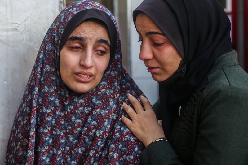 The loved ones of victims of an Israeli strike in Rafah mourn and comfort each other. Getty Images