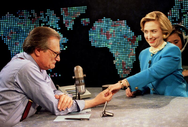 Sporting a new hairdo, first lady Hillary Rodham Clinton shows her wedding ring to Larry King on  May 5, 1994. Reuters