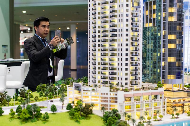 Abu Dhabi, United Arab Emirates, April 19, 2017:     A visitor takes a picture with his smartphone of Eshraq Properties' Marina Rise development during the second day of Cityscape Abu Dhabi at Abu Dhabi National Exhibition Center in Abu Dhabi on April 19, 2017. Christopher Pike / The National

Job ID: 46714
Reporter: Lucy Barnard
Section: Business
Keywords: *** Local Caption ***  CP0419-bz-cityscape-01.JPG