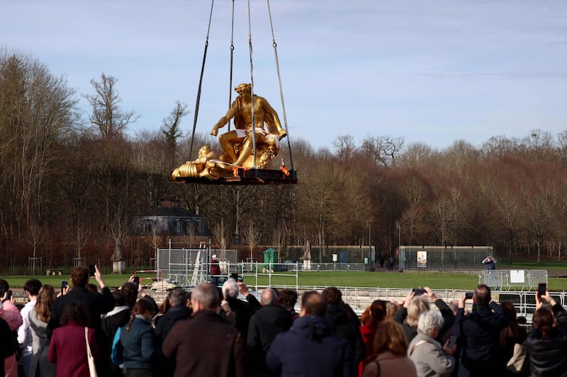 A crane carries the sculpture of 'Apollon sur son char' to reinstall it in the Apollo Fountain after its restoration in Chateau de Versailles, Paris. AFP