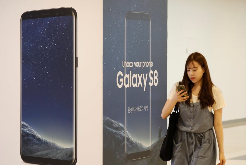 A woman walks past an advertisement promoting Samsung Electronics's Galaxy S8 at its office building in Seoul, South Korea July 4, 2017. Picture taken on July 4, 2017. REUTERS/Kim Hong-Ji