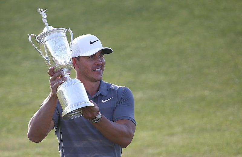 epaselect epa06817424 Brooks Koepka of the US celebrates with the US Open Championship Trophy after winning the 118th US Open Championship at Shinnecock Hills Golf Club in Southampton, New York, USA, 17 June 2018.  EPA/CJ GUNTHER